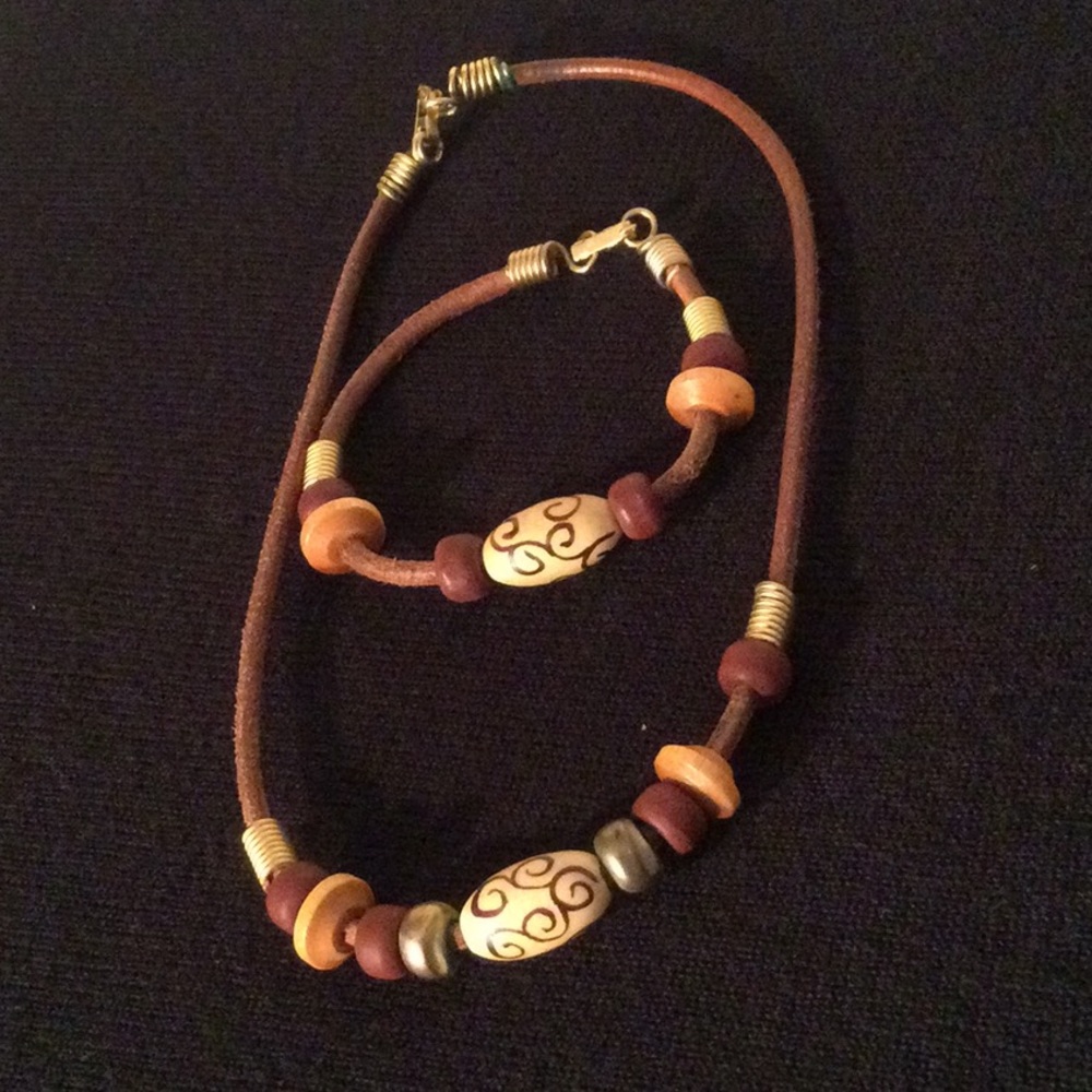 Necklace and bracelet with different shaped beads in brown tones.
